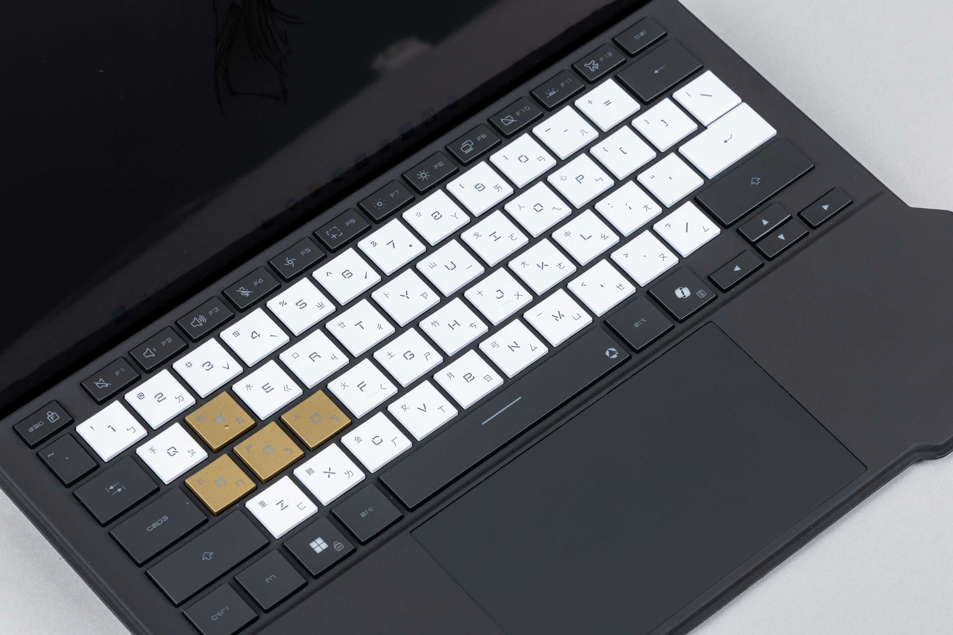 鍵盤採用黑、白、金三色配置，字母鍵區為純白鍵帽，周邊功能鍵為黑色，玩家最常用的 WASD 鍵則特別採用 Decennium Gold 塗裝。